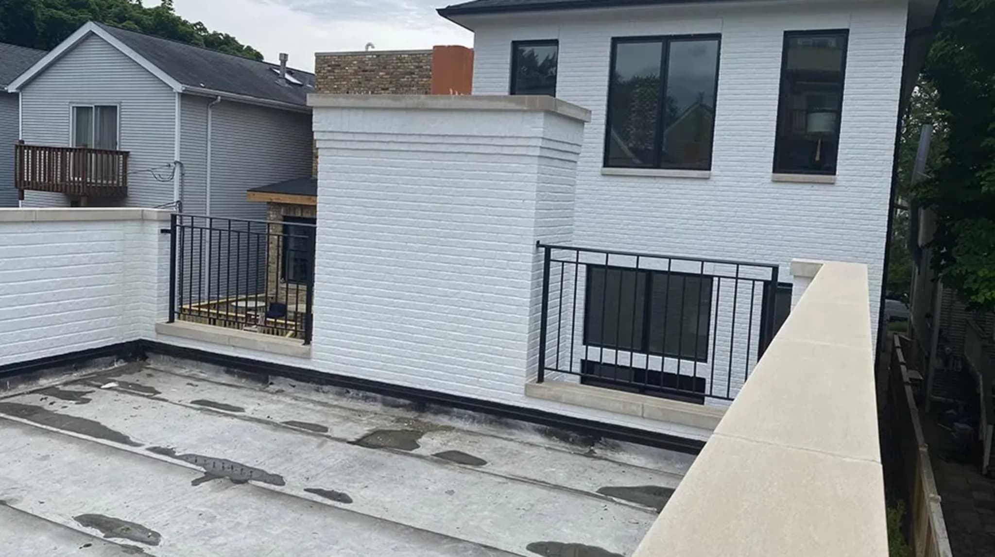 White Brick Garage Deck - Before